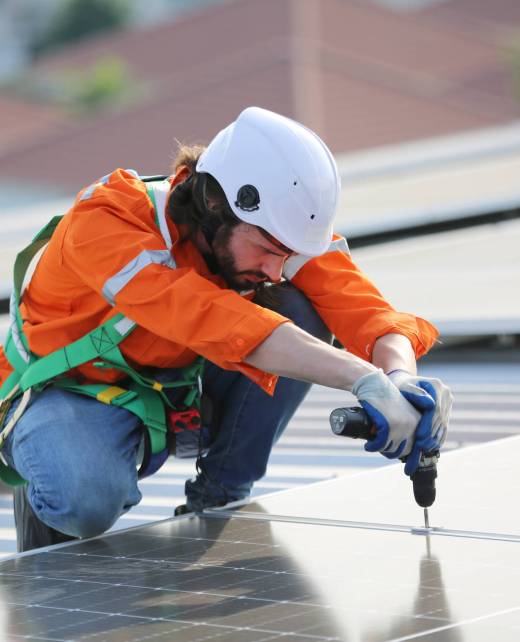 professional technician or engineer installing solar panels, Alternative energy for installed solar panels in use on roof of home